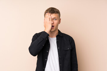 Young handsome man covering a eye by hand