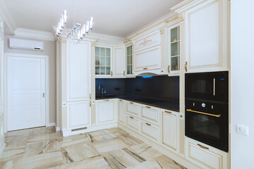 Designer kitchen with furniture, without table and chairs, electric stove, oven and microwave, kitchen sink and air conditioning. Very light and clean. Electric lighting