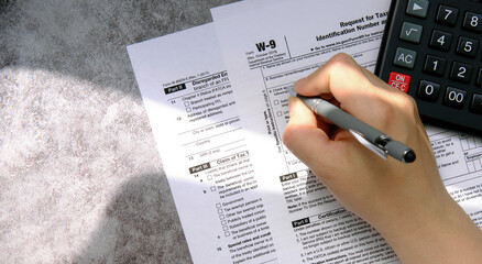 Filling out a tax form and counting taxes on the calculator