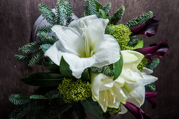 top view closeup bouquet made from white lily, purple calla, and fresh greenery