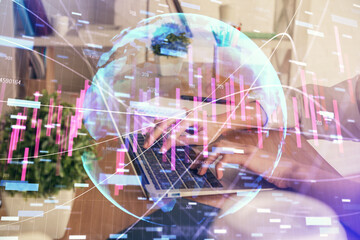 Fototapeta na wymiar Double exposure of woman hands typing on computer and forex chart hologram drawing. Stock market invest concept.