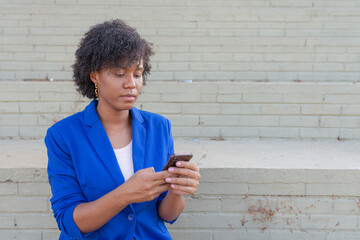 Young woman using mobile at street.