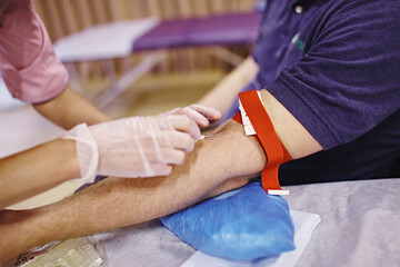 Blood sample. World blood donor day. Close up of a doctor drawing a blood sample. Phlebotomy. 