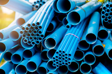 Selective to blue plastic pipe background. PVC pipes stacked in warehouse of construction site.