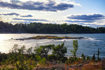 Water crashing over a tiny island during a storm