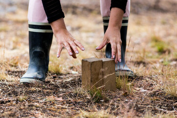Woman arranging pieces in a game of kubb