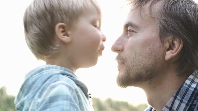 Close-up portrait cute toddler child boy kisses his father on nose. Tenderness, love, dad and son relationship, fathers day concept. Happy family moments.