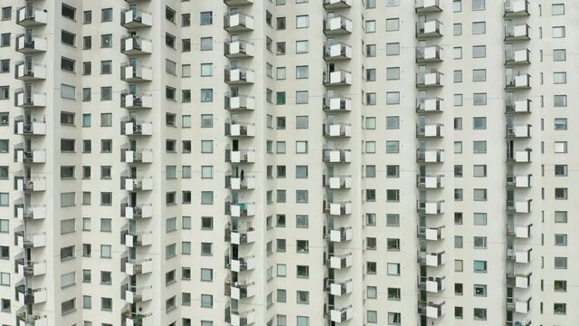 Exterior of a white high rise residentail apartment building & windows