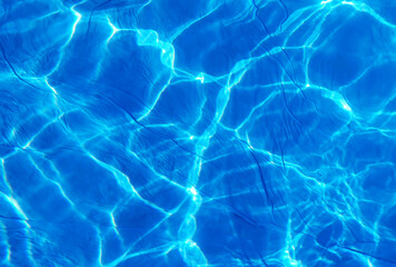 Fototapeta na wymiar pool water, sunlight reflection, unusual texture of abstraction