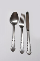 cutlery set of silver spoon, fork and knife isolated on a white backround