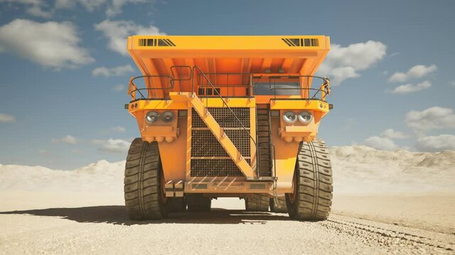 Big dump truck driving through the middle of a vast sand quarry in a loop. 4KHD