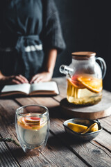 Woman cooks in a vintage kitchen on wooden tablet. Healthy drink, Eco, vegan.