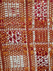 Red fabric with patterned squares, abstract structure