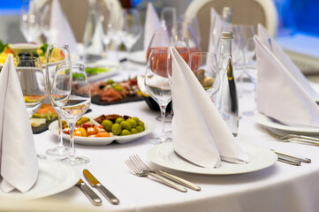 fabric napkins on a banquet table, festive table setting in a restaurant