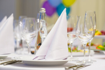 fabric napkins on a banquet table, festive table setting in a restaurant