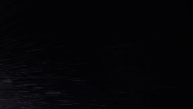 Water spray swirling snow storm falling black background texture effect