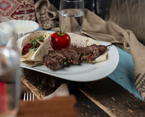 Meat barbecue served with tomato served in lavash