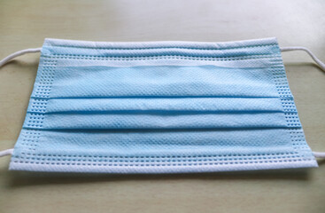 Isolated corona mask with rubber ear straps to cover the mouth and nose. Procedure mask from...