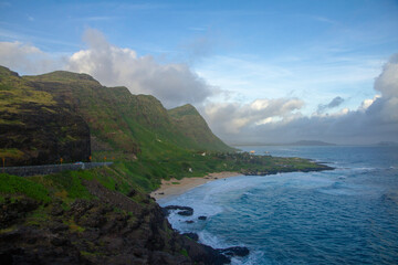 Fototapeta na wymiar Surf Beach at bottom of scenic green mountains in Hawaii, landscape 
