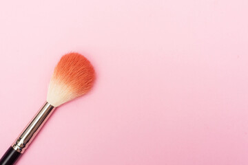 Goat hair brush for makeup and blush is on a pink background