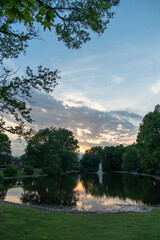 Fototapeta premium East Brunswick, New Jersey - May 25, 2019: A portrait view of a local pond can be found in the heart of the town with a sidewalk wrapping around it for a scenic and leisurely stroll. 