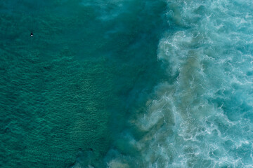 aerial view of ocean waves breaking out at sea.
