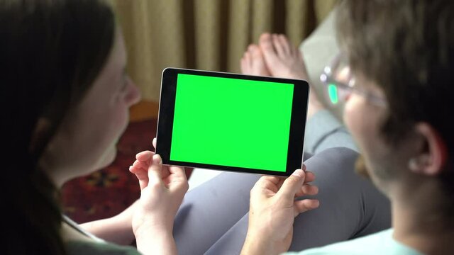Blonde woman having green screen video call via tablet talking to someone. Friends, facetime, online, internet, long distance communication, chatting concept. skype chatting with grandmother.
