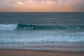 Silhoette of surfer at sunrise over Maroubra beach in Sydney Australia