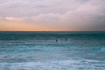Silhoette of surfer at sunrise over Maroubra beach in Sydney Australia