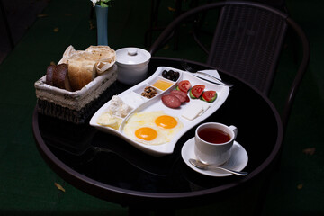 Breakfast platter with fried eggs on black table