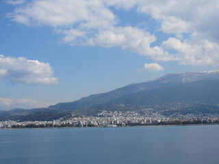 Port of Patras, Greece with blue sky and mountains in the distance seen off a ferry from Italy