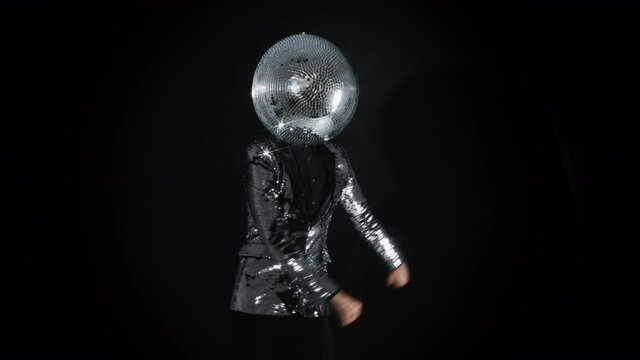 Mr disco ball wearing silver jacket dancing
