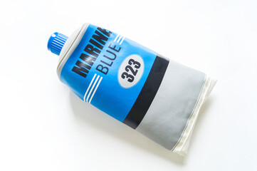 Blue paint in a tube. White background.
