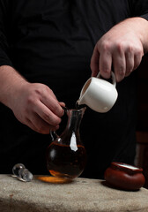 Cook making salad with vinegar