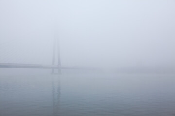 bridge over the river in the fog