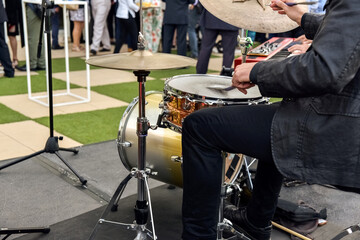 Valencia, Spain - June 20, 2019: Musician playing jazz to the battery hired to entertain the attendees of a business event.