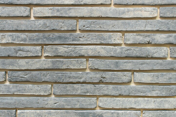 New materials in construction. The artificial stone imitating a brick wall. Seamless texture.