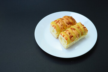 Cheese bread in a plate on black background 