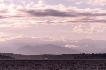 View towards the Olympic Mountains across from Alki Beach in West Seattle on a late summer day....