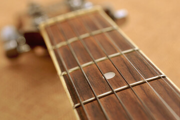 The neck of the guitar close up.