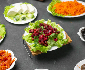 Russian vinegret salad with chopped beatroots on a lettuce leaf