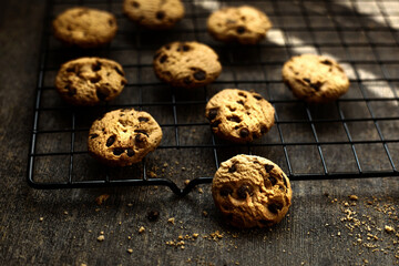 chocolate chip cookies on cooling rack in dark food  concept
