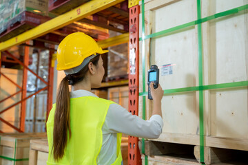 Worker working checking and scanning package products by laser barcode scanner in the large warehouse,Logistic and export concept.