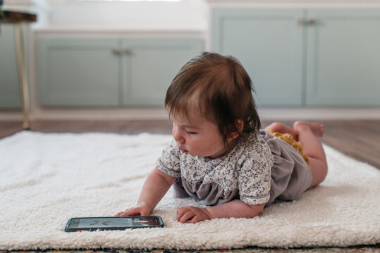 Little girl playing with a phone