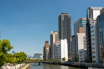 Fototapeta na wymiar View of office buildings along Tosabori river, shot from Yodoyabashi bridge in Osaka, Japan