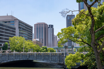 Fototapeta na wymiar Yodoyabashi bridge and office buildings along Tosabori river in Osaka, Japan