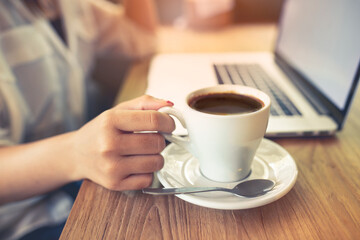 Closeup of a woman hands typing a laptop on the table .business concept
