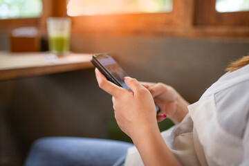 Closeup of a woman hands typing a laptop on the table .business concept