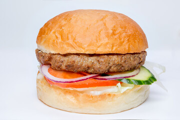 small hamburger with cutlet, onion, tomato and cucumber