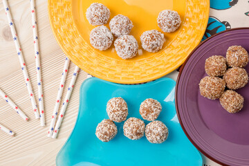 balls of dried fruit sprinkled coconut shavings